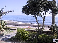 Foto: Blick auf Garten, Strand und Meer